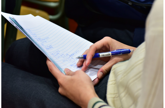 A student jotting down the main points.