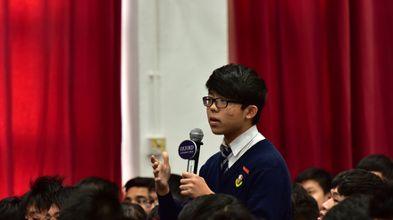 A student asking the speakers some questions during the Q&A session.