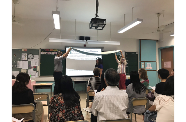 Ms Kempston demonstrates how to use props in the performance of choral speaking.