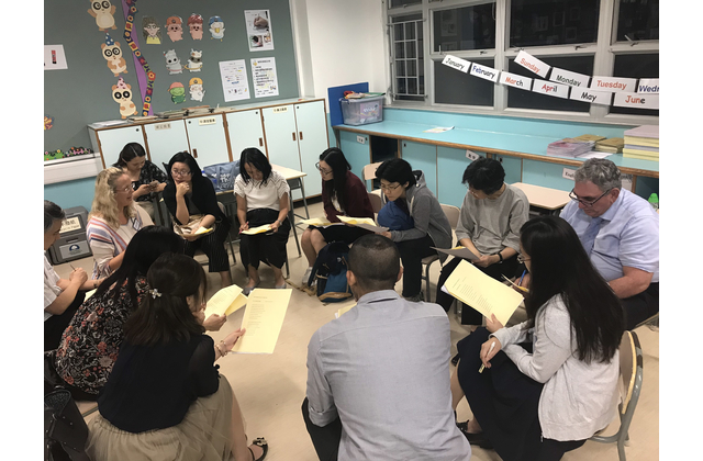 Teachers work together to interpret poems.