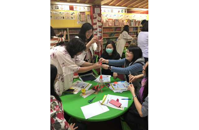 Participants try to build a tower as high as possible. 